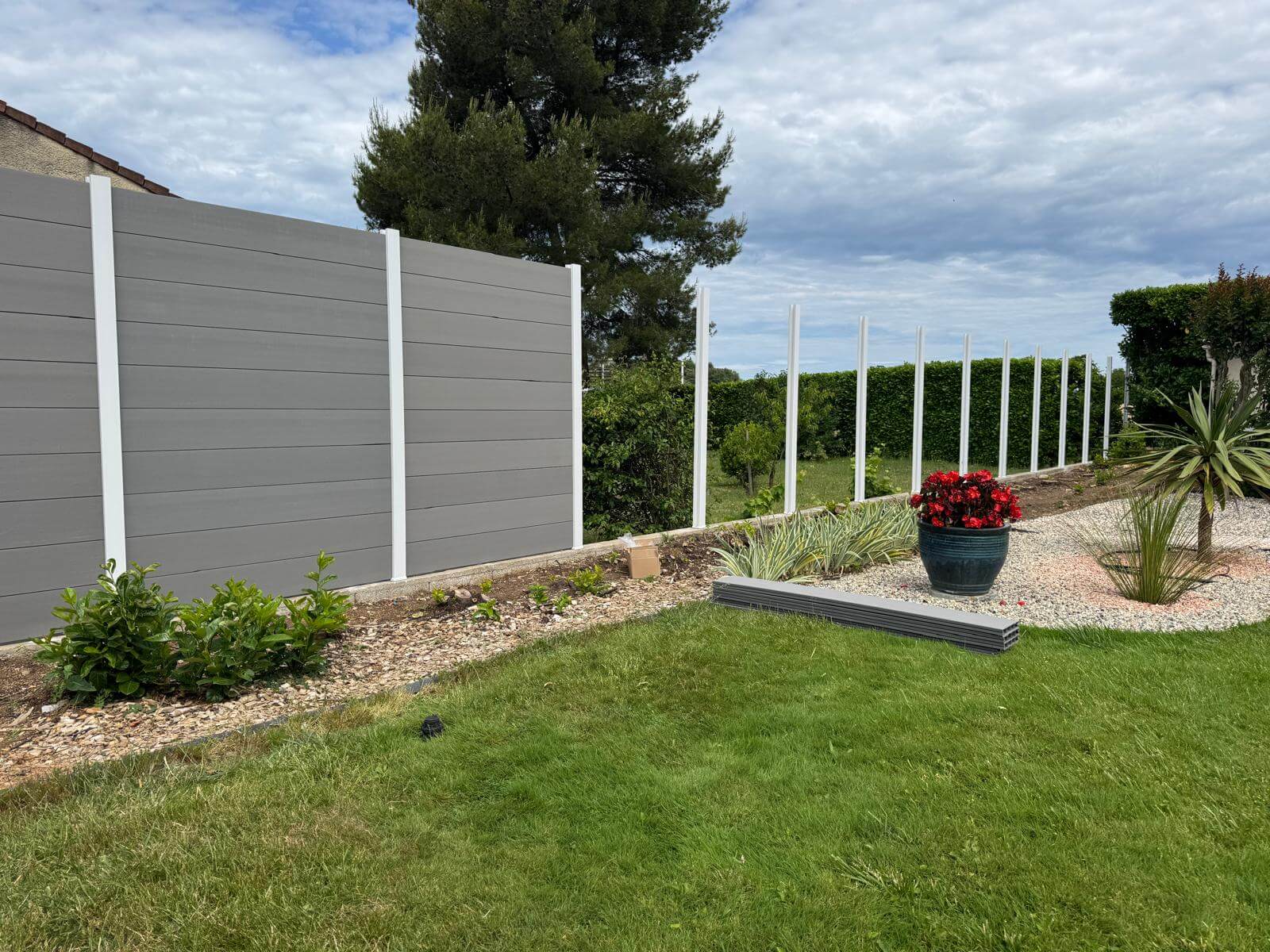 Aperçu des travaux de clôture en cours de réalisation. Transformation du jardin avec une solution durable et esthétique pour gagner en intimité.